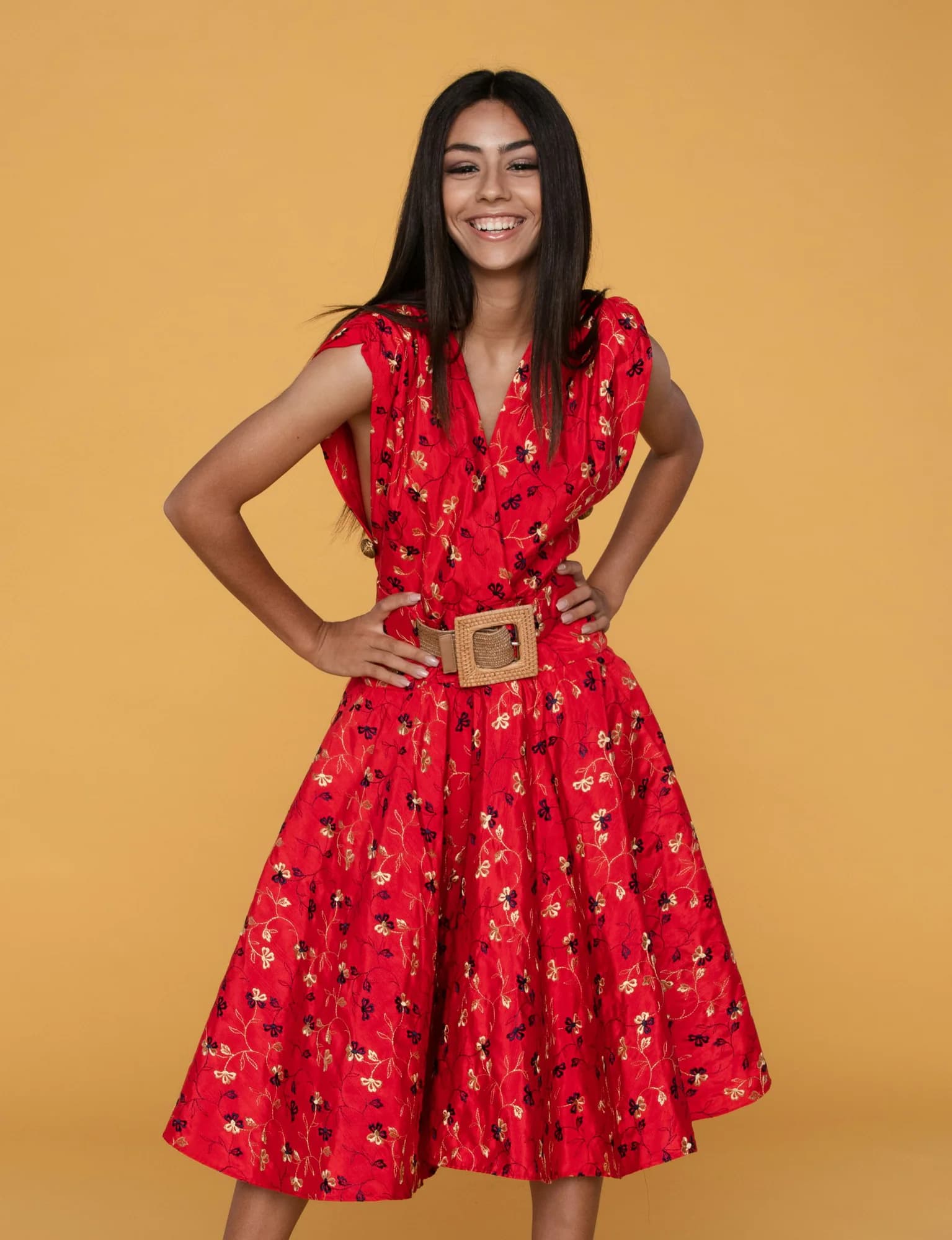 Smiling woman wearing a red belted midi dress