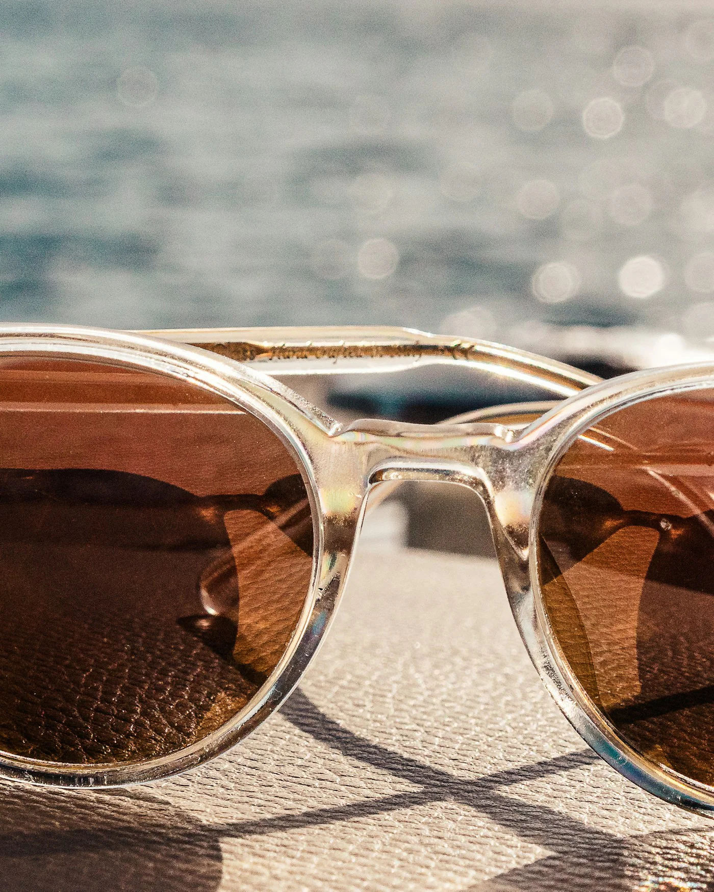 Tortoiseshell sunglasses on a sunny beach — detail